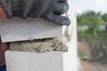 Worker aligns with a spatula, lay brick cinderblocks Royalty Free Stock Photo