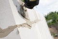 Worker aligns with a spatula, lay brick cinderblocks Royalty Free Stock Photo