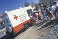 A worker in an American Red Cross Disaster Service vehicle handing out supplies to people after the 1994 earthquake