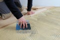 Worker applied adhesive for parquet