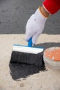 Worker applies bitumen mastic on the foundation