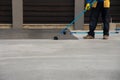 Worker applies bitumen mastic on the foundation