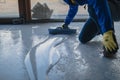 The worker applies gray epoxy resin to the new floor