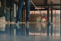 The worker applies gray epoxy resin to the new floor