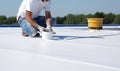 Worker applies insulation coating on the concrete surface. Fixing a leaking roof by applying waterproofing solution. Generative AI