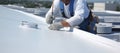 Worker applies insulation coating on the concrete surface. Fixing a leaking roof by applying waterproofing solution. Generative AI