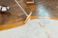 The worker applies yellow epoxy resin to the new floor