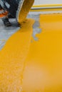 Worker applying epoxy and polyurethane flooring system Royalty Free Stock Photo