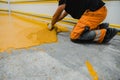 Worker applying epoxy and polyurethane flooring system Royalty Free Stock Photo