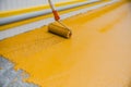 Worker applying epoxy and polyurethane flooring system Royalty Free Stock Photo