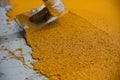 Worker applying epoxy and polyurethane flooring system Royalty Free Stock Photo