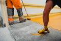 Worker applying epoxy and polyurethane flooring system Royalty Free Stock Photo