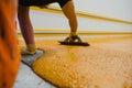 Worker applying epoxy and polyurethane flooring system Royalty Free Stock Photo