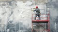 Worker applying foam insulation on a wall using a roller Royalty Free Stock Photo
