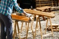 Worker applying fresh wood treatment paint