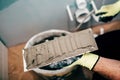 Worker applying mortar on ceramic tiles and working on rebuilding a bathroom