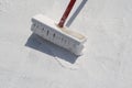 Worker applying white roof coating Royalty Free Stock Photo