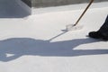 Worker applying white roof coating Royalty Free Stock Photo