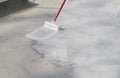 Worker applying white roof coating Royalty Free Stock Photo