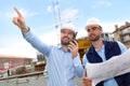 Worker and architect watching some details on a construction