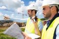 Worker and architect watching some details on a construction