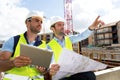 Worker and architect watching some details on a construction