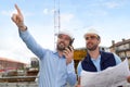 Worker and architect watching some details on a construction