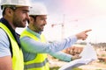 Worker and architect watching some details on a construction