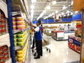 Worker arranges food products on a shelf in a grocery