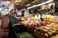 Worker arranges produce on a vegetable stand at Pike Place Market