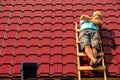 a worker asleep during a break sunbathing on the stairs on the roof Royalty Free Stock Photo