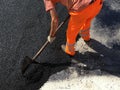 a worker asphalt road in the summer