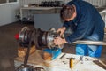 Worker assembles machine part in a factory