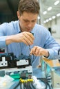 Worker assembling electronic components.