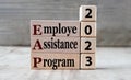 Worker Assistance Program 2023 - words on wooden blocks on gray background Royalty Free Stock Photo