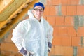 Worker attaching thermal insulation to roof