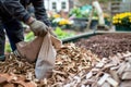 worker bagging wood chips for sale at a garden center