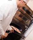 Worker with baked pizza posing