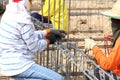 Worker bending steel rod for construction job