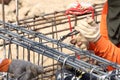 Worker bending steel rod for construction job