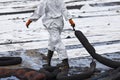 A Worker in biohazard suits used Oil Containment boom as cleani Royalty Free Stock Photo