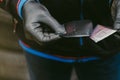 Worker with black rubber gloves in a workshop opening radial tire patch Royalty Free Stock Photo