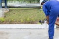 Worker in a blue factory suit Wear a white helmet Installing fire hose There is a grass background