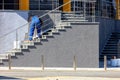 Worker in blue overalls puts decorative facade plaster on the wall of the building