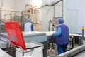 Worker in a blue robe and a cap inspect the production department of dairy factory Royalty Free Stock Photo