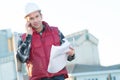 Worker with body warmer call on site Royalty Free Stock Photo