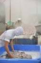 A worker is boiling octopus before transferring to process for exporting in a seafood factory