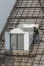 Worker breaking a house down with his hammer in Vietnam