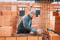 worker, bricklayer and mason working with bricks and building interior walls Royalty Free Stock Photo