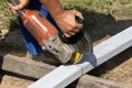 Worker builder cutting metal detail with an angle grinder on a construction site Royalty Free Stock Photo